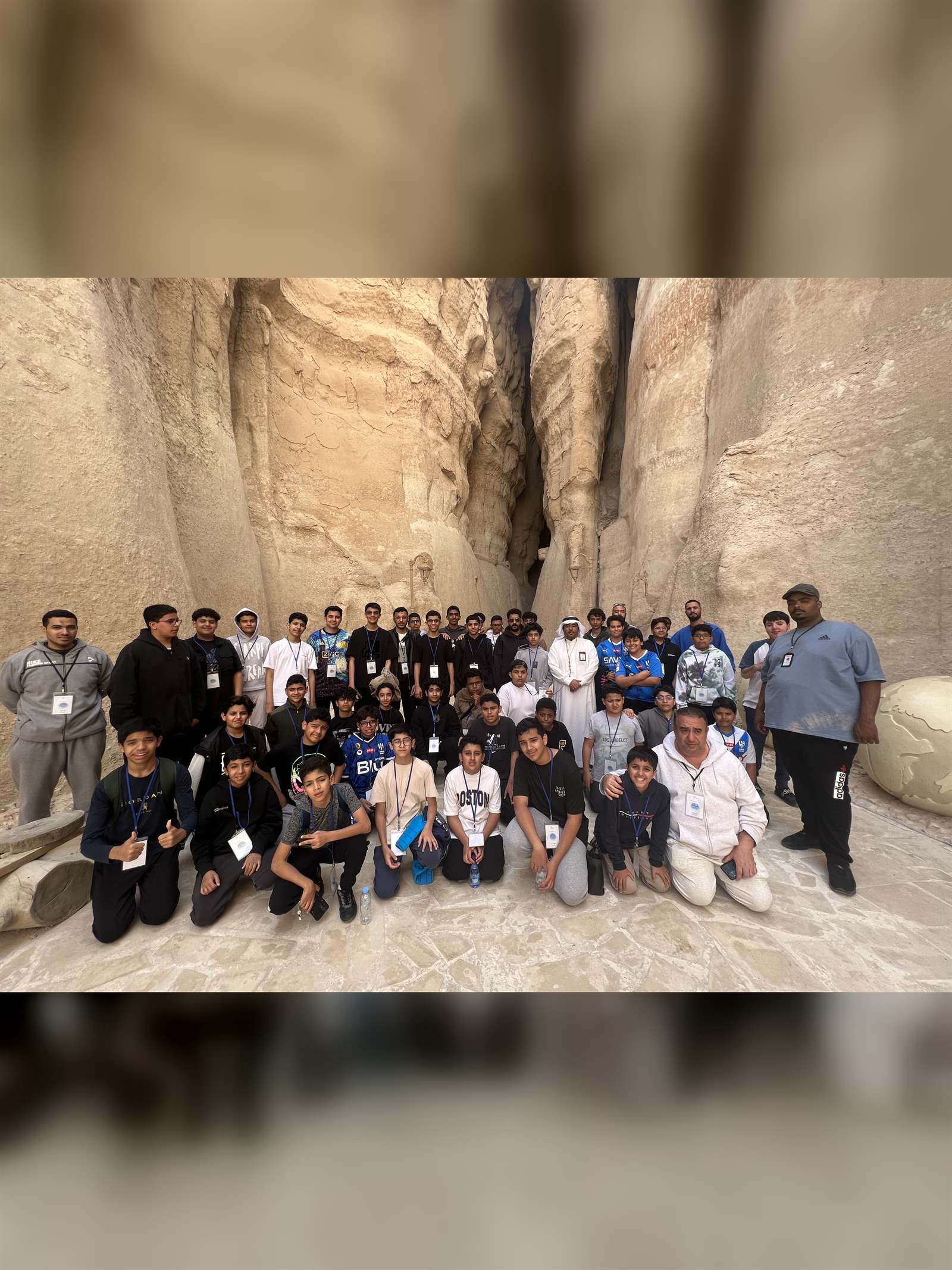 A student group inside the rock passage at Al-Qarah