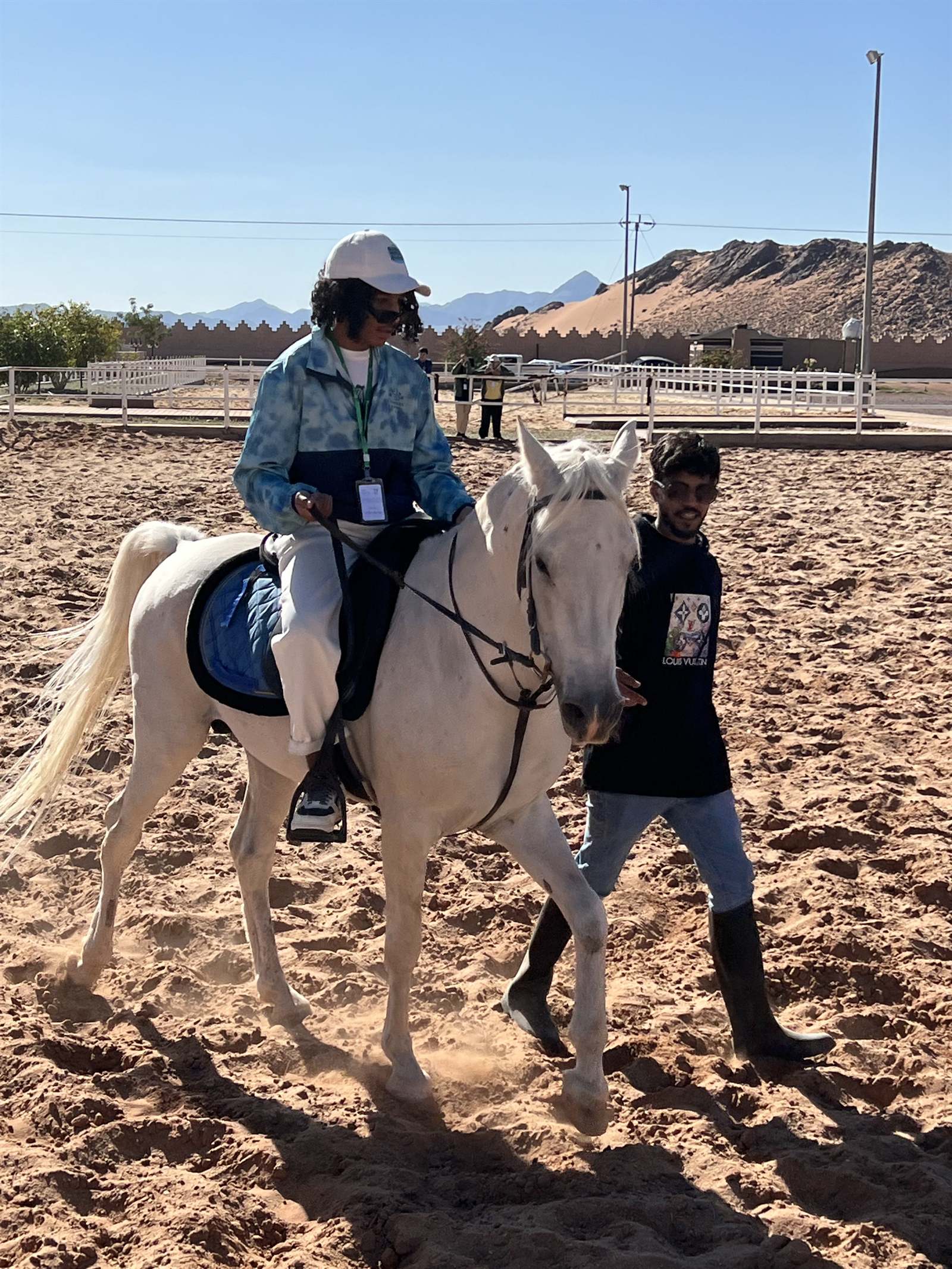 Horse riding in an open arena ringed by the AlUla hills