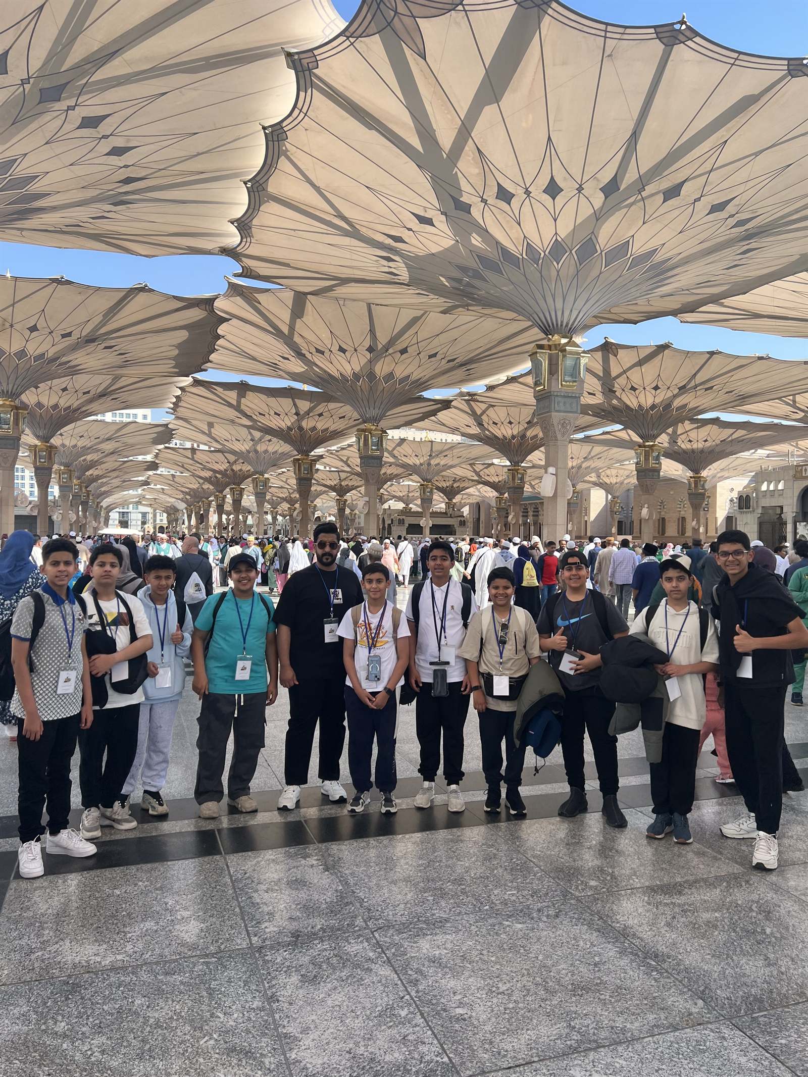A student group beneath the canopies of the mosque courtyard