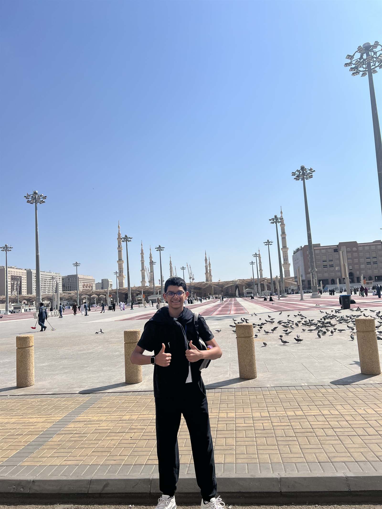 A wide plaza before the mosque with a single figure in the distance